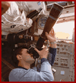  Kaleri with long lens camera, photographs Mir through shuttle flight deck windows  